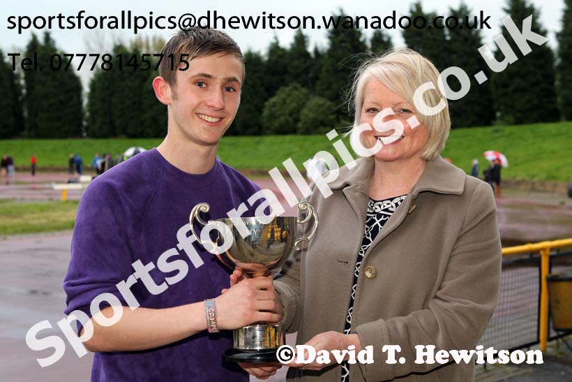 Michael Wilson (Sunderland) receives the Jimmy Hedley 800 metres Cup from Diane Holmes, daughter of the late Jimmy Hedley, North Eastern Grand Prix, Monkton Stadium, Jarrow. Photo: David T. Hewitson/Sports for All Pics